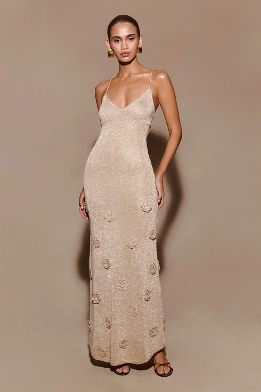 a beige floor-length slip dress with delicate floral embroidery and thin spaghetti straps featuring crochet floral lace and glitter accents in a mermaid maxi style