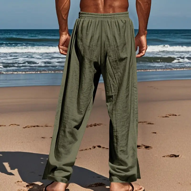 olive green men’s linen straight leg pants with elastic waistband and side button detail shown from the back side
