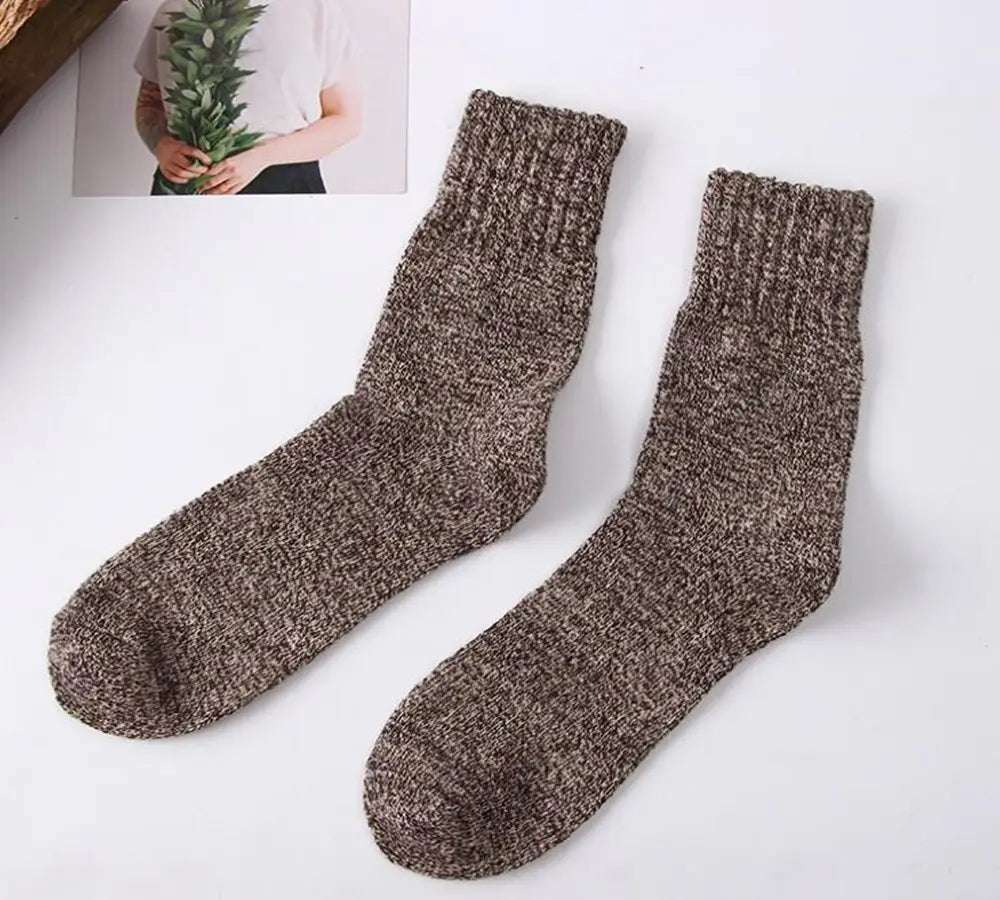 A pair of cozy heathered brown knit men’s rabbit fur winter socks with ribbed cuffs.