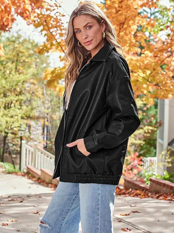 Black faux leather bomber jacket oversized relaxed fit coat with elasticized waistband and front zipper closure.