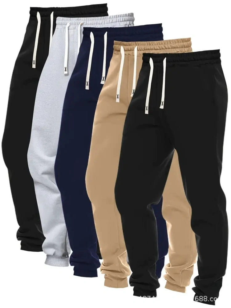Men’s 5-pack solid jogger pants featuring five pairs of sweatpants in black white navy blue beige and dark gray with matching drawstrings and a small x logo.