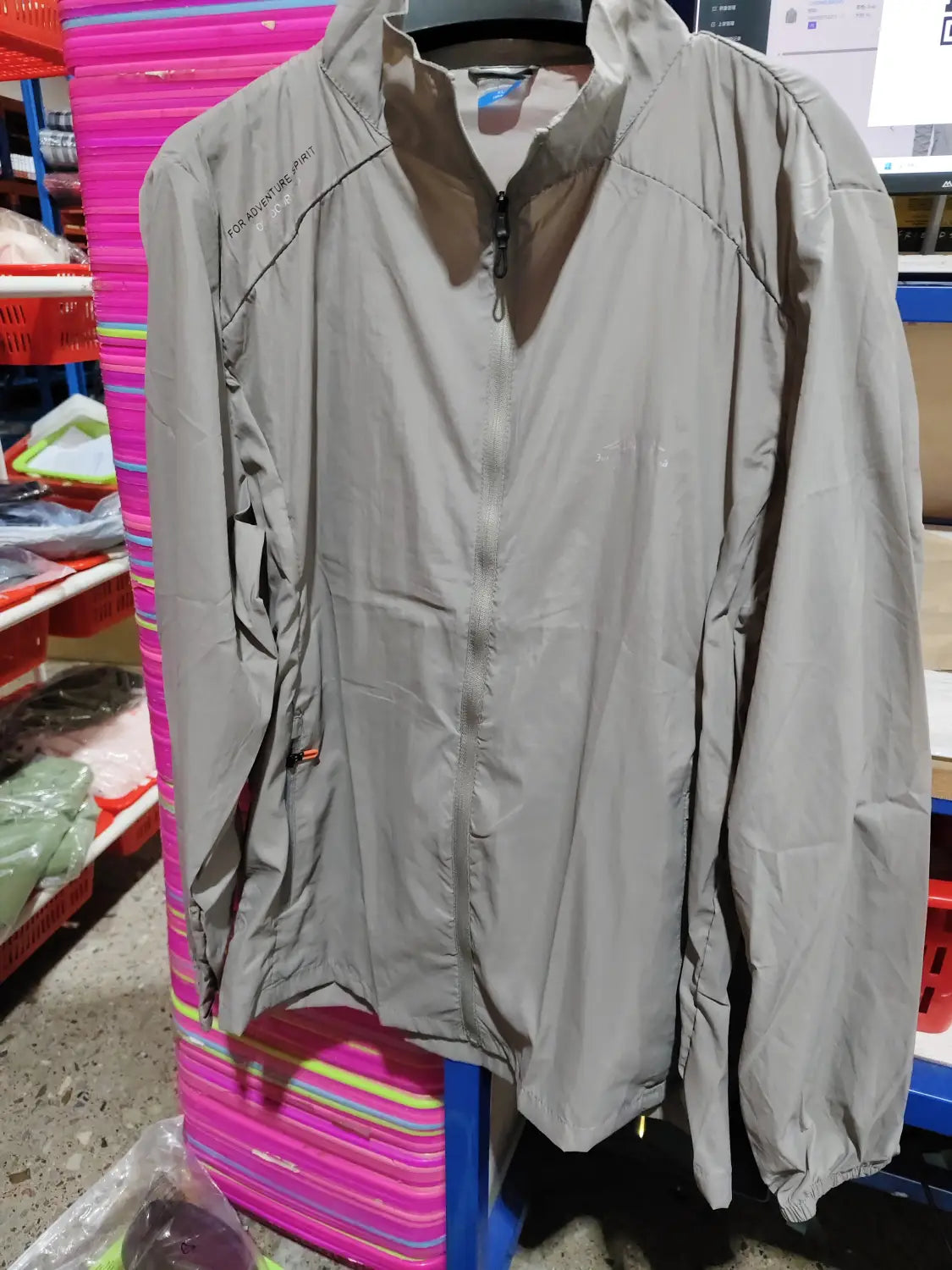 Men’s ultrathin sun protective sports jacket in gray lightweight fabric with subtle sheen featuring a full-length zipper and elastic cuffs.
