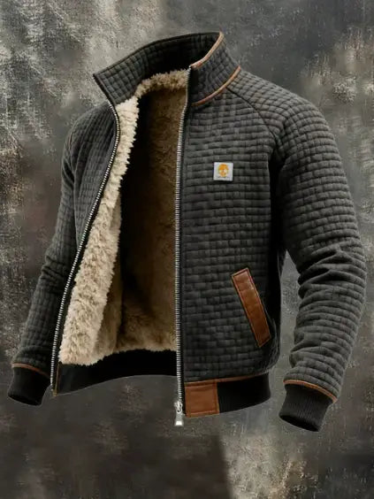 Veste en cuir matelassée doublée en shearling pour homme, en gris foncé, avec une doublure en shearling beige moelleuse et des empiècements en cuir marron sur les poches, les poignets et la tirette de fermeture éclair.