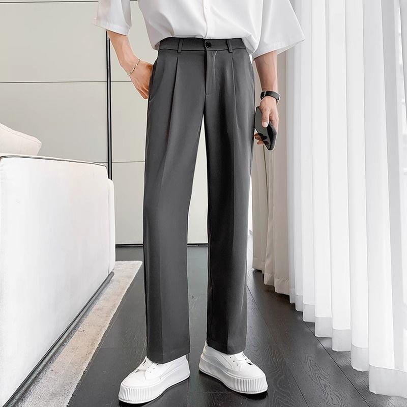 Men loose fit straight leg suit pants in dark gray with a sleek modern cut and subtle pleated texture.