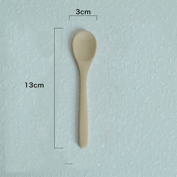 A light beige slender wooden spoon with a smooth finish and rounded bowl from a natural eco-friendly kitchen utensils wooden spoon set.