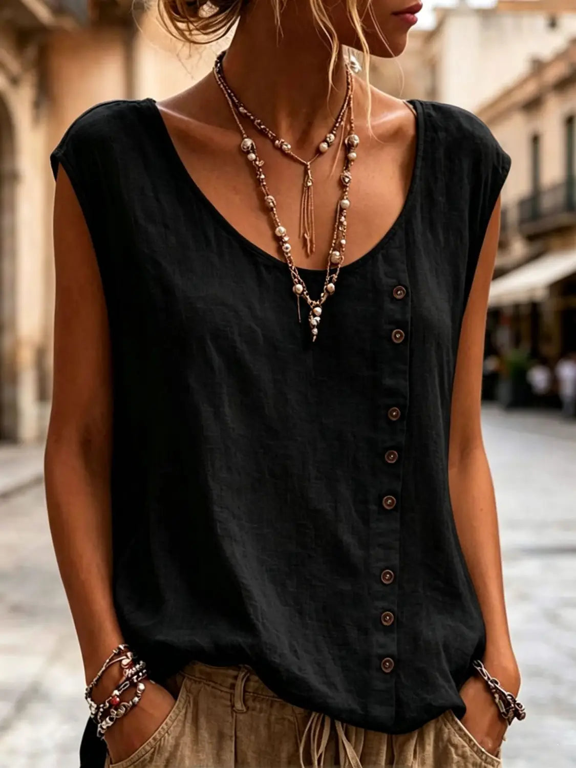 Black sleeveless vest loose casual top with a v-neck and button-down front perfect for everyday wear.