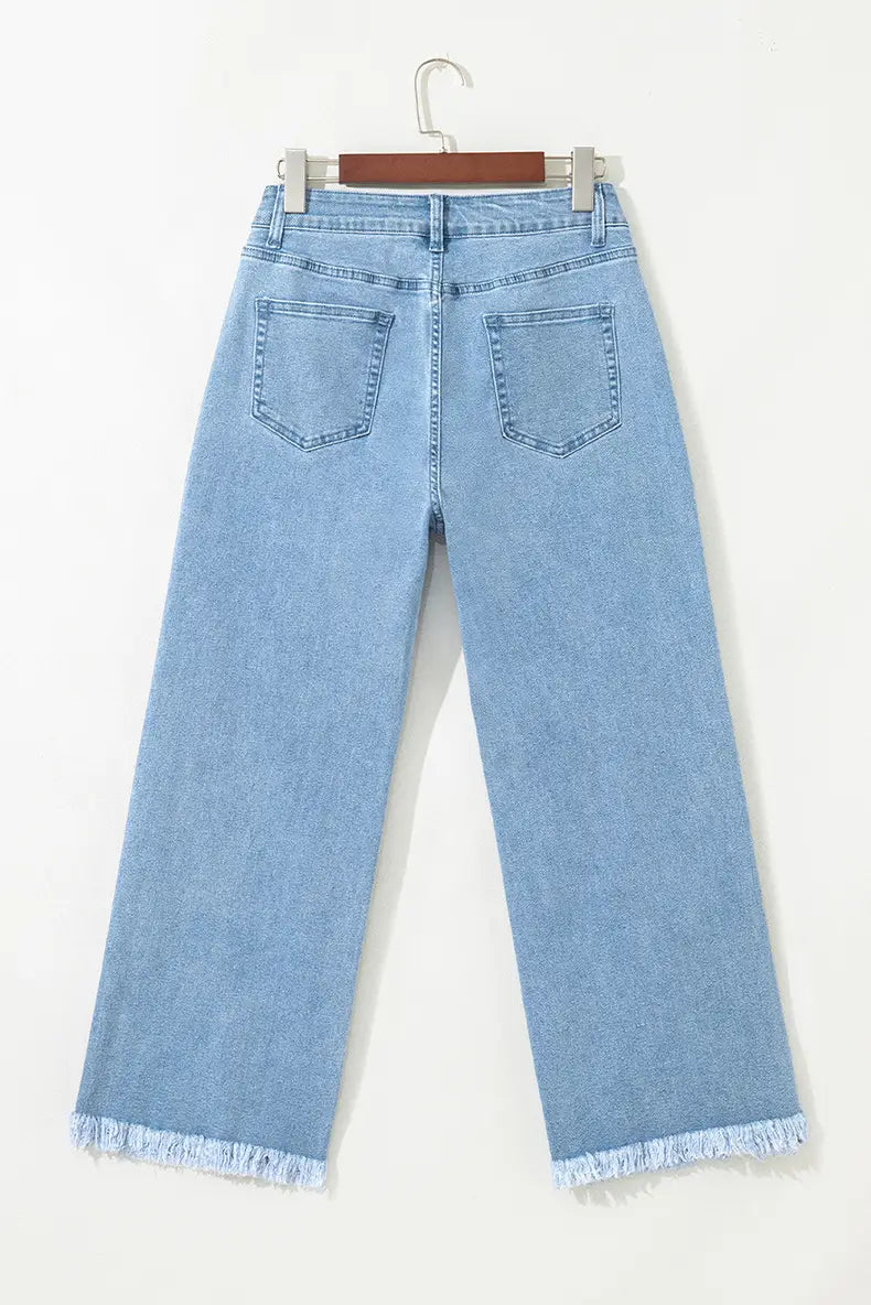 Jean à taille haute en denim rose effiloché, délavage clair, à jambes larges, à coupe décontractée et ourlets effet usé.