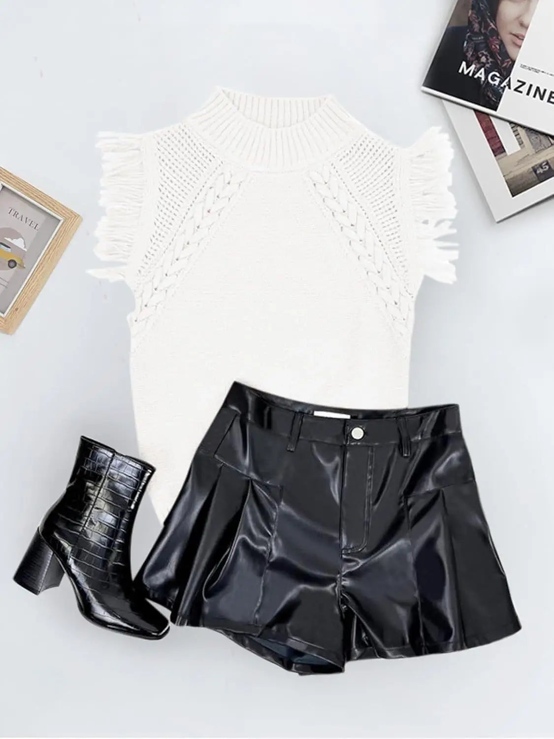 White hand-woven fringed sleeveless knit sweater vest featuring a high neckline and intricate lace-up detailing on the shoulders.