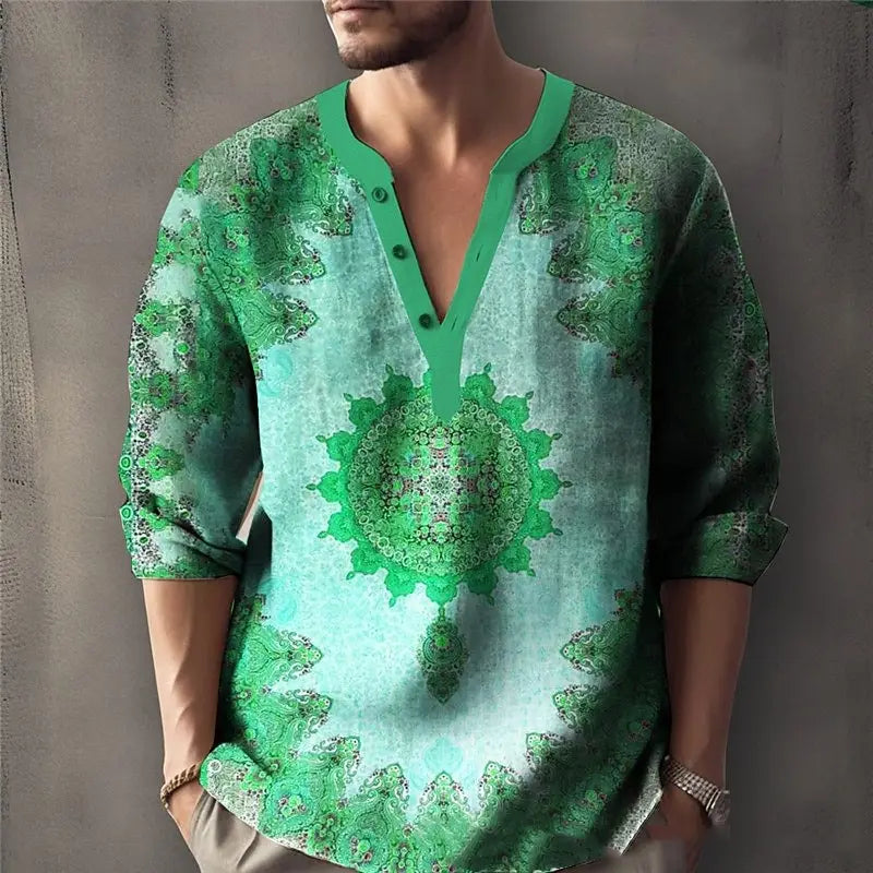 Un hombre que viste una camisa larga de lino con cuello en V y estampado de mandala en color verde, con puños remangados.