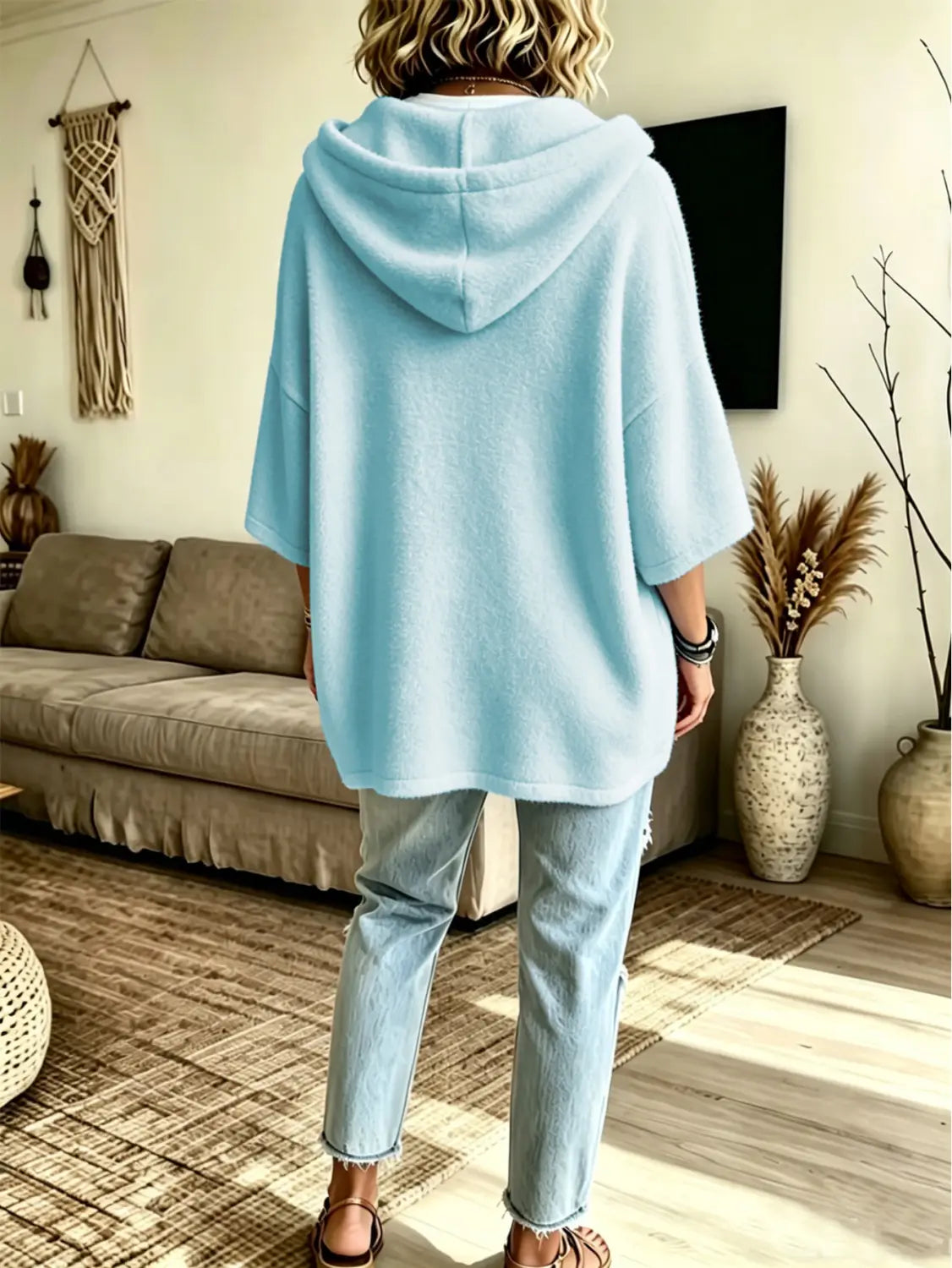 Light blue oversized fleece hooded top with soft texture and three-quarter sleeves.