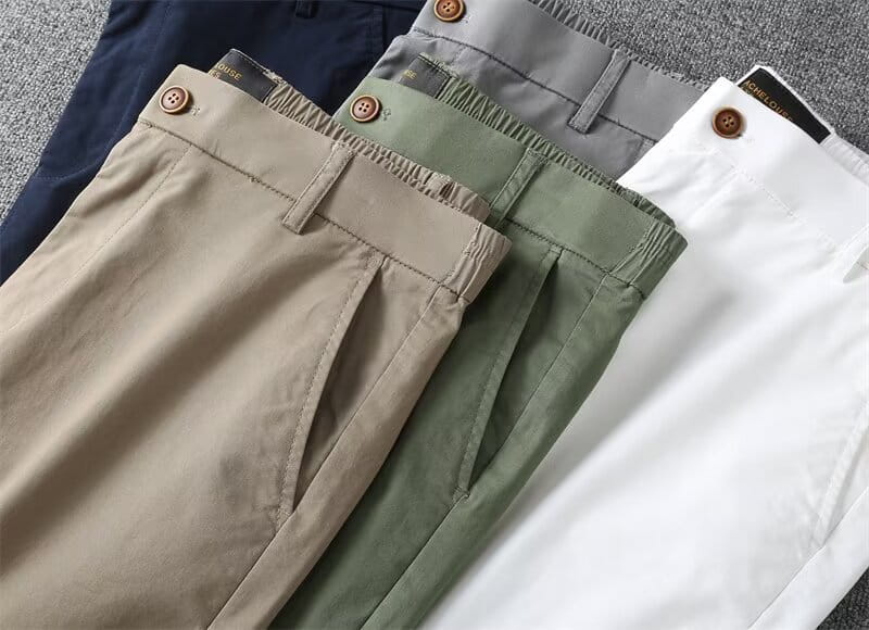 Beige chino pants with a buttoned waistband and subtle pleats designed as men casual slim fit cargo shorts.
