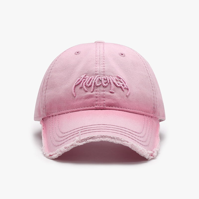 A faded pink distressed cotton baseball cap featuring brown embroidered phycener lettering on the front.