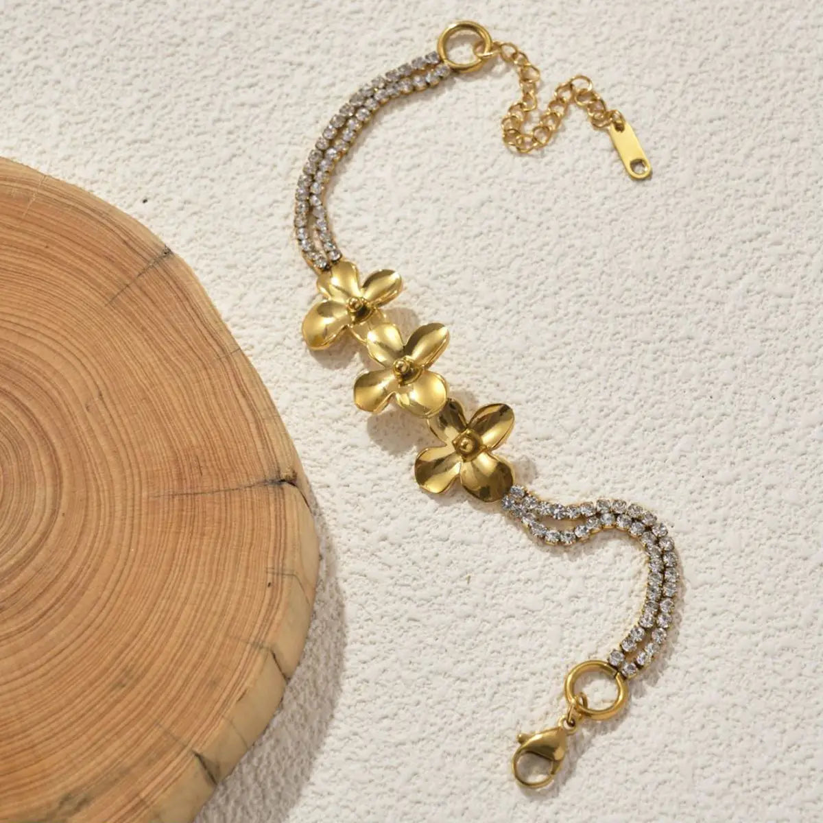 18k gold plated crystal flower double strand bracelet featuring a gold-toned chain with clear crystals and three elegant flower charms.