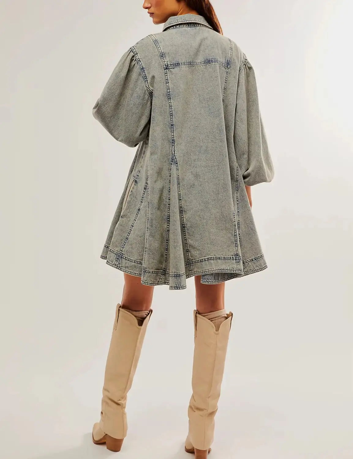 A light-wash denim shirt dress with lantern puffed sleeves, patch pockets, and a flared hem.