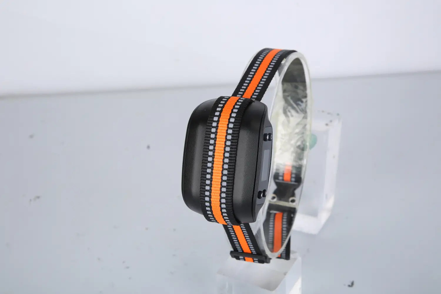 Black and orange reflective waterproof dog collar with a rectangular electronic transmitter for GPS wireless dog fence and tracking.