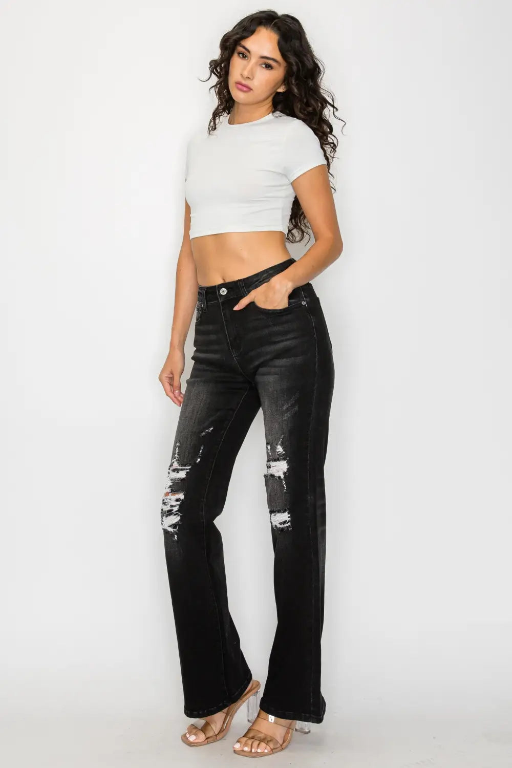 Black low rise ripped flare jeans in distressed black denim with ripped knee details