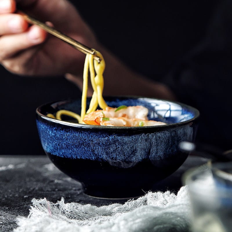 Deep blue ceramic ramen bowl with a textured speckled glaze and subtle white patterned rim measuring 8.5 inches ideal for serving noodles.