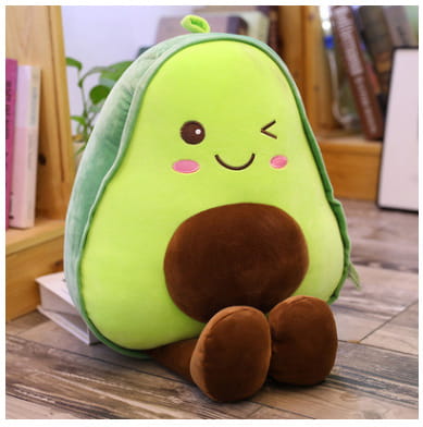 a plush avocado-shaped backpack with a bright green body brown pit and feet and embroidered facial features designed as a soft fruit pillow for kids