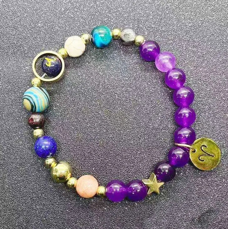 A colorful natural amethyst and agate twelve zodiac beaded bracelet featuring purple, blue, and gold-toned stones with a star charm and zodiac symbol pendant.