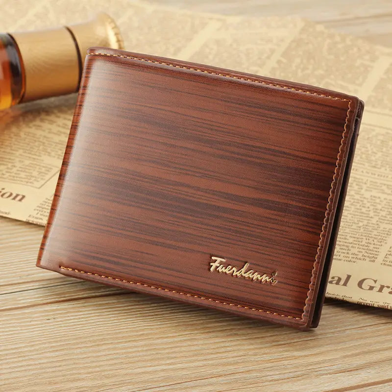 brown leather mens bifold wallet with card slots and id window featuring wood-grain texture gold-colored stitching and metallic fuerdann branding
