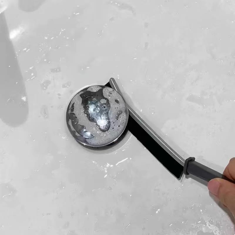 A sleek metallic drain cover with a rounded reflective surface and black rubber seal designed for gap cleaning brushes for tile and crevice 5pcs.
