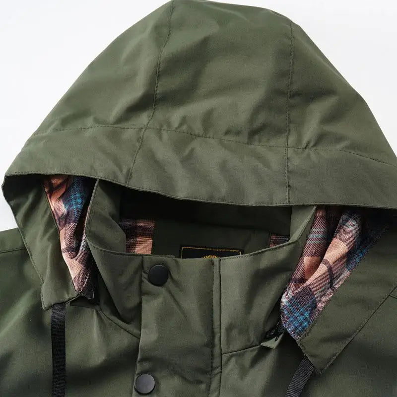 Mens outdoor fleece hooded jacket in olive green with a plaid lining in shades of pink, blue, and brown designed as a casual shell coat.