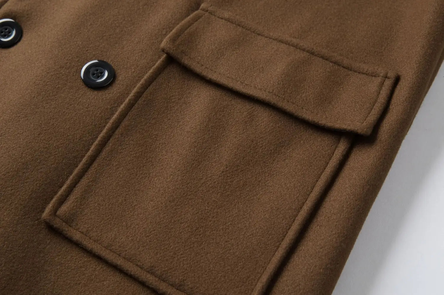 Men double breasted mid length wool overcoat in brown with black buttons and a flap pocket.
