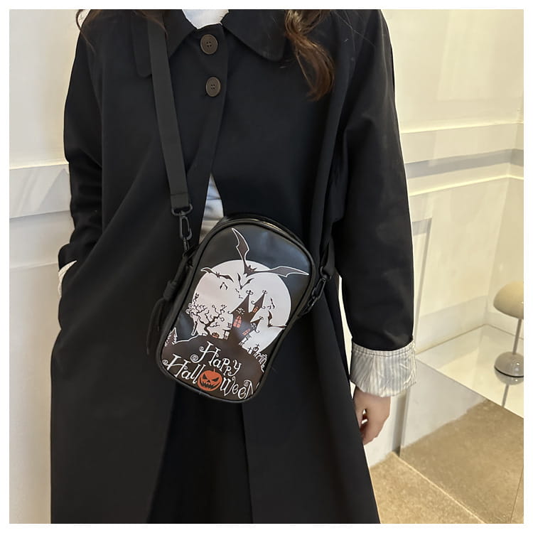 Black embroidered Halloween floral and pumpkin crossbody bag featuring a white moon bats and happy Halloween text design for festive use.