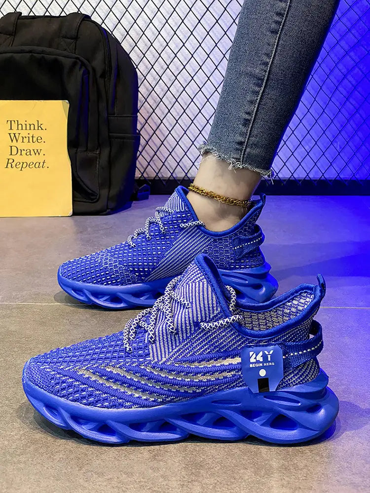 Flyknit mesh platform running shoes for men in vibrant royal blue featuring a chunky sculpted rubber sole and silver metallic laces.