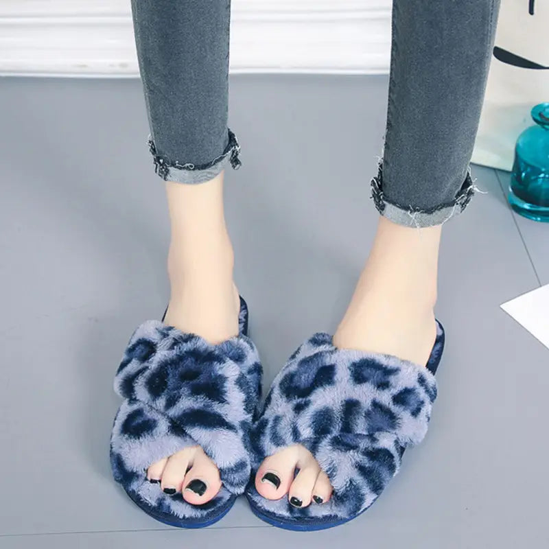 Leopard fuzzy cross strap plush house slippers featuring blue and gray leopard print and a fuzzy material for indoor comfort.