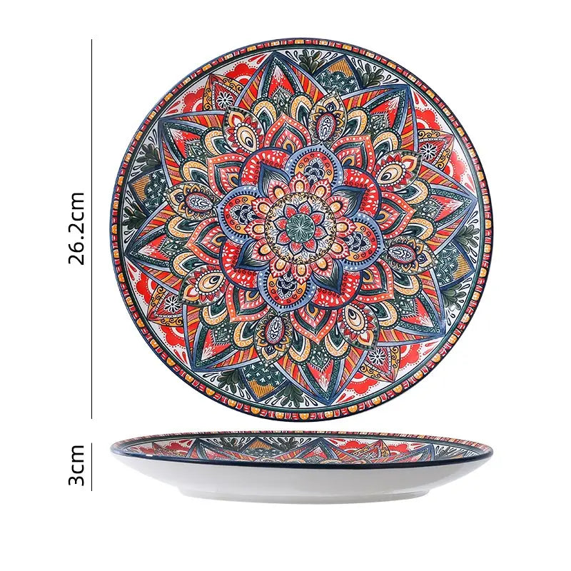 A vibrant hand-painted ceramic mandala serving bowl with a detailed design in reds blues and gold tones with a 400ml capacity.