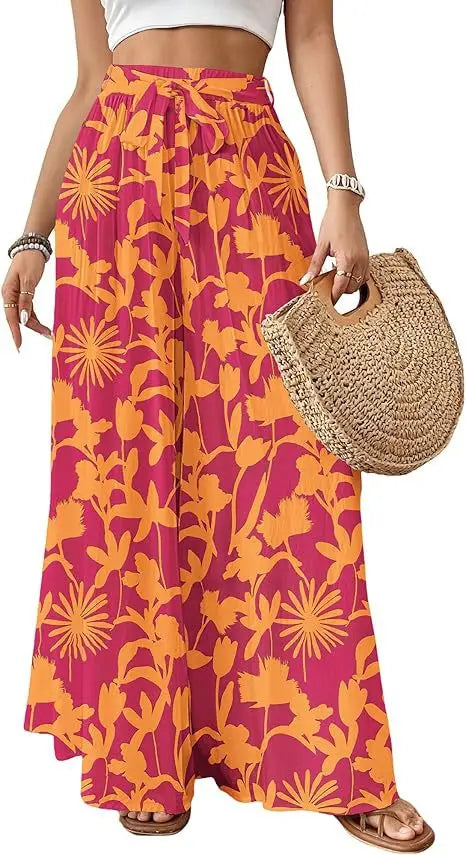 Jupe longue maxi à taille haute au motif floral rose vif et orange, avec une silhouette fluide, conçue comme un pantalon évasé pour femmes.