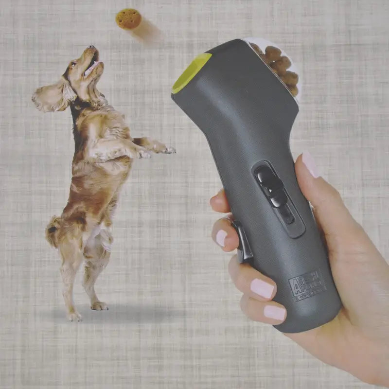 Gray and lime green dog training snack launcher with a sleek ergonomic design for pet treat shooting.