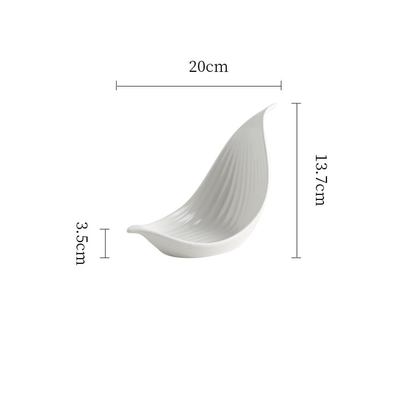A sleek white ceramic plate shaped like a leaf with subtle vertical ridges designed as an irregular serving dish.