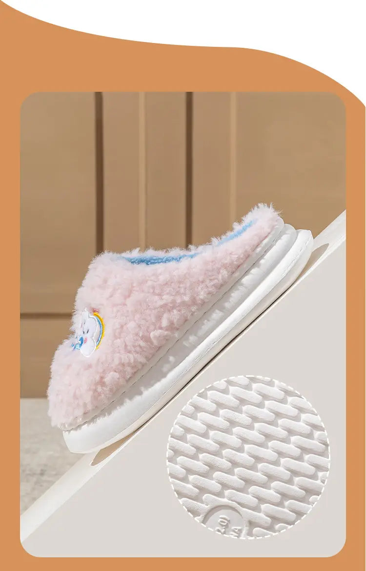 pink fluffy slipper with small unicorn and rainbow embroidered on the side featuring white rubber sole from the smiling cloud and rainbow plush cotton slippers collection