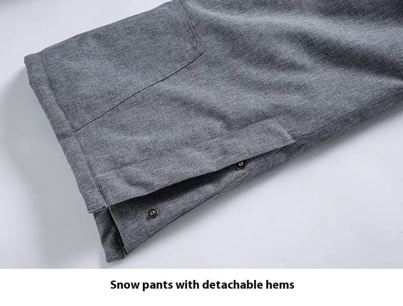 Men waterproof thermal snow pants in gray with detachable hems, textured fabric, and subtle stitching details.