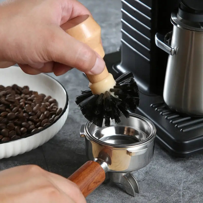 Wooden-handled coffee portafilter brush with black bristles from a coffee machine cleaning brush set with four pieces and wood handles.