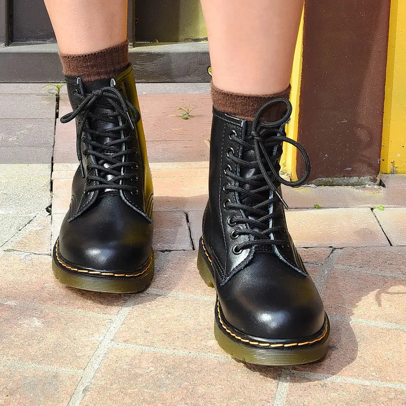 Black leather martin boots in burgundy with yellow stitching showing the back side.