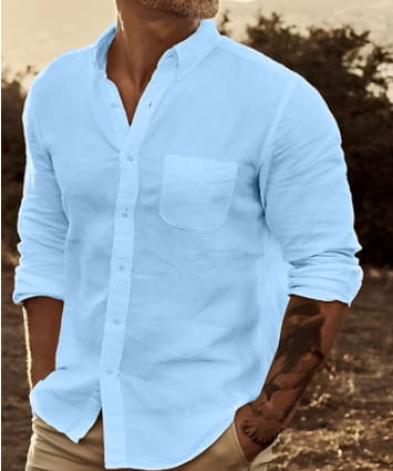 Men’s slim fit cotton long sleeve button down shirt in light blue with chest pocket and rolled up sleeves.