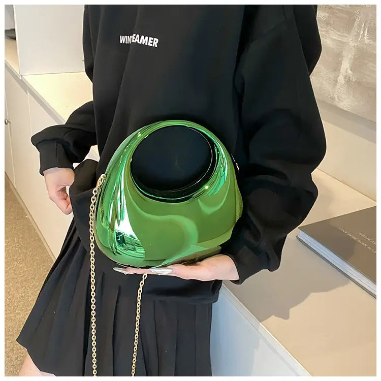 Shiny emerald green glossy ceramic acrylic gold chain handbag with metallic clutch bag design.