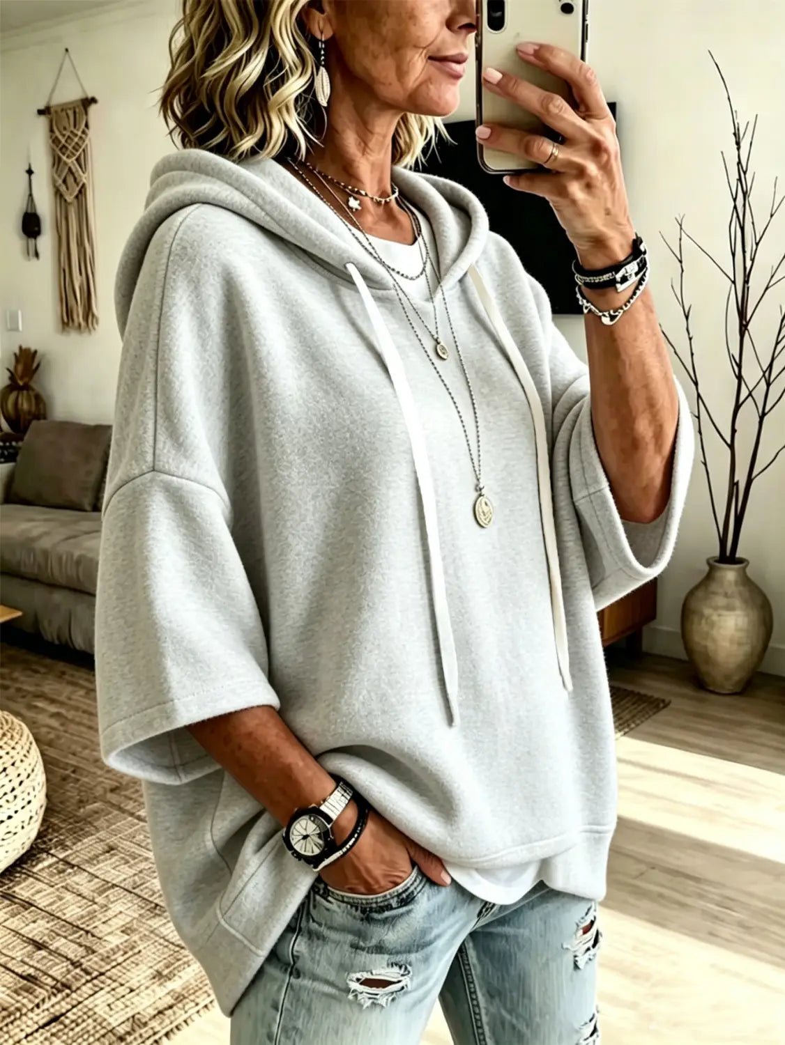light gray oversized fleece hooded top with three-quarter sleeves made of soft fleece material and matching drawstrings