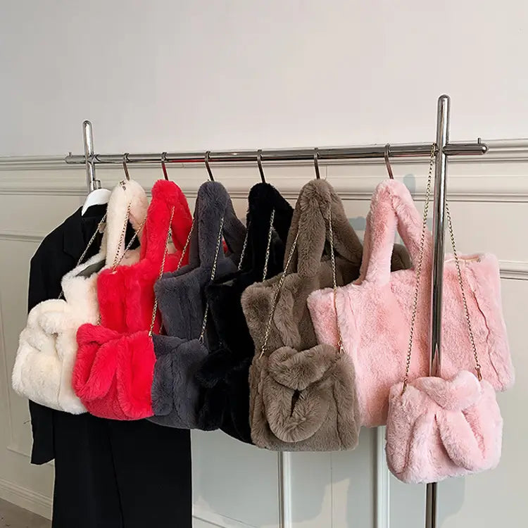 A collection of plush faux fur tote bags with chain strap shoulder bags in white red gray black brown and pink colors.