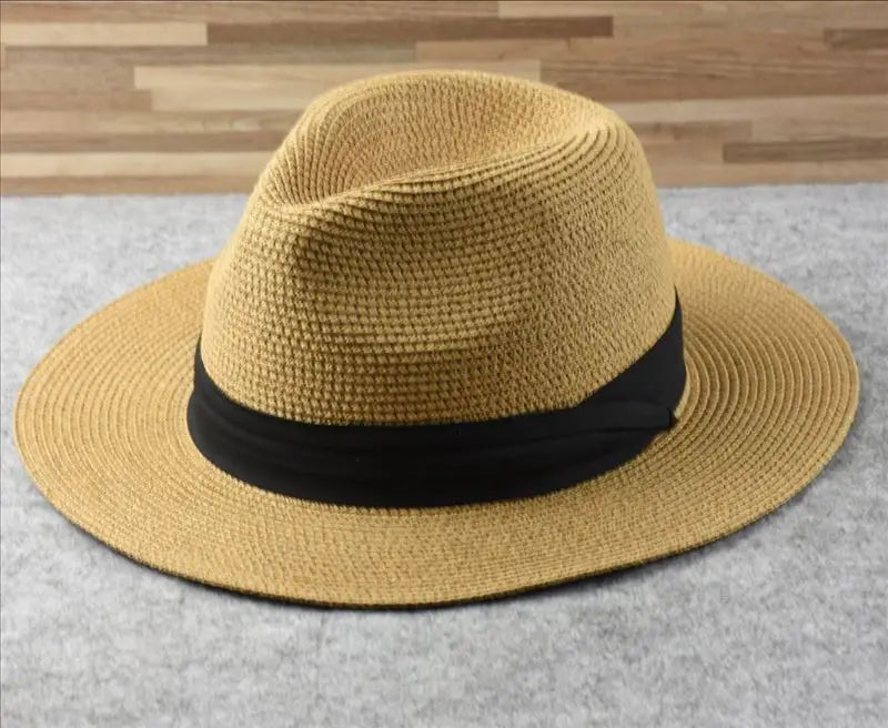 Beige straw fedora hat with black ribbon band foldable for sun protection men.