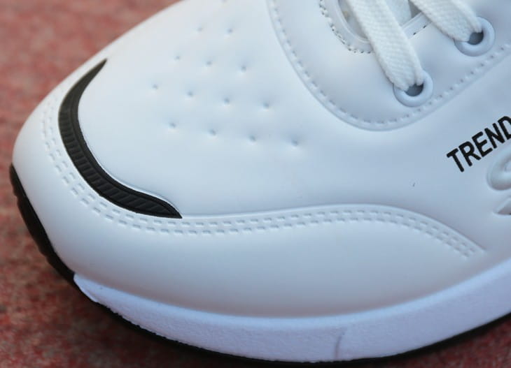 men’s casual sportswear leather running shoe in white with a black swoosh logo and perforated upper.