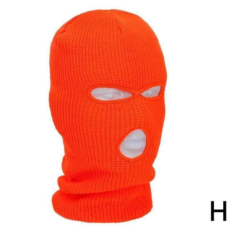 Bonnet cagoule tricoté orange vif, avec des ouvertures pour les yeux et la bouche, conçu comme un masque chaud pour le cyclisme.