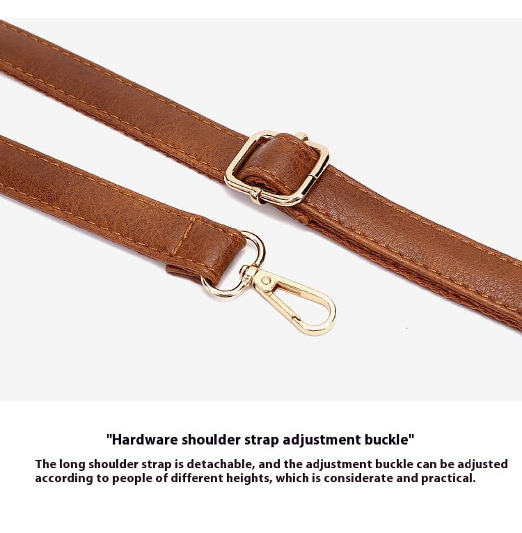 brown leather shoulder strap with gold-tone metal buckle and swivel hook on a leather hobo bag with tassel and front zipper pockets