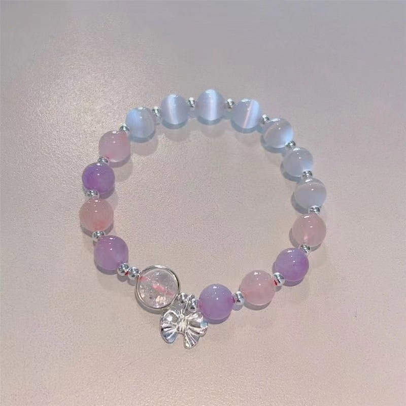 Crystal Butterfly Cat’s Eye Bead Bracelet with pastel-colored lavender pink and light blue stones and a silver butterfly charm.