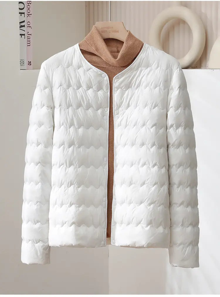 White quilted puffer jacket with a soft wavy stitched pattern and a cozy beige turtleneck underneath in the Puff Jacket Ruffled Crew Neck style.