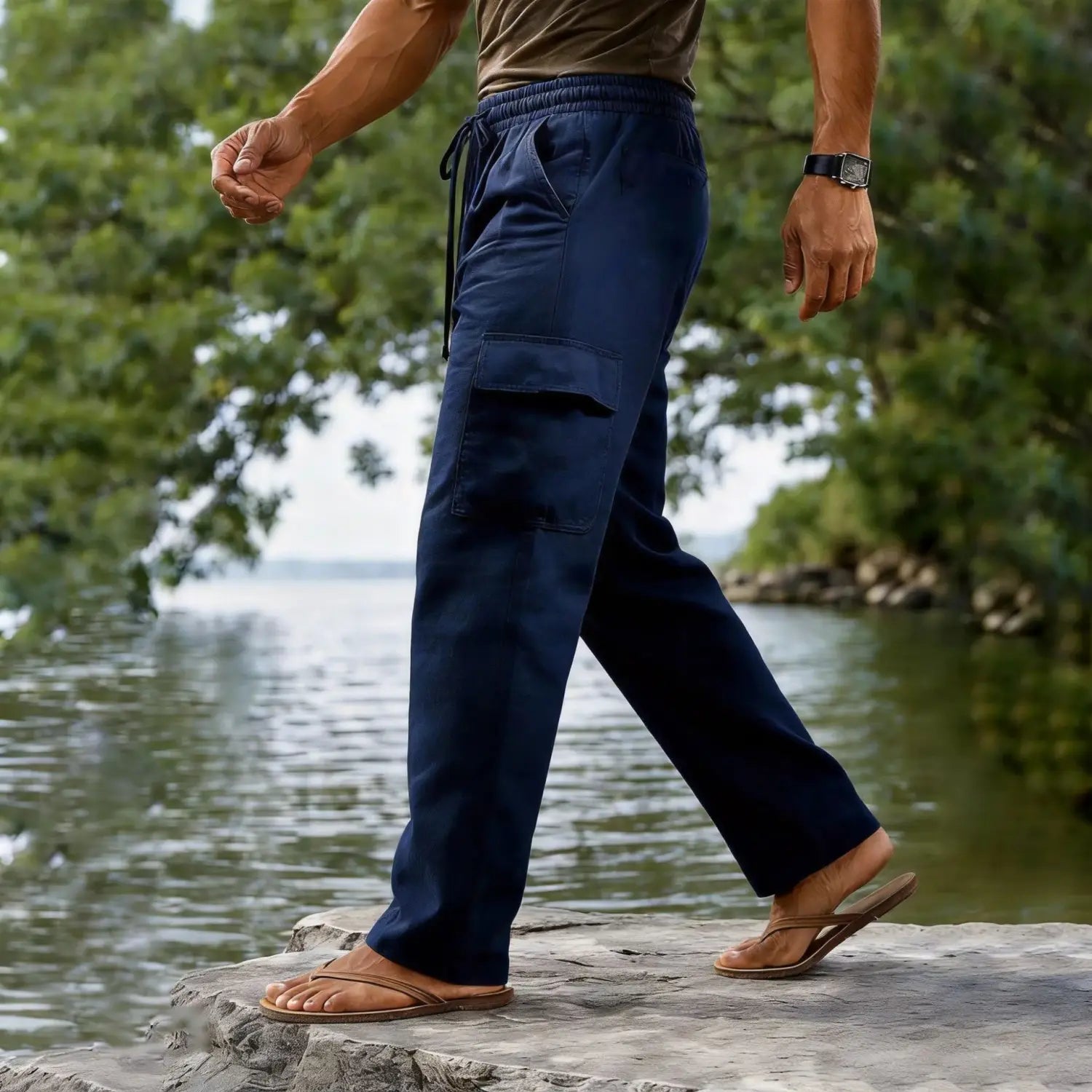 navy blue men cotton linen cargo pants with elastic waistband and drawstring featuring large side pockets and a relaxed casual straight leg fit.