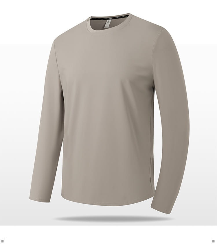 Camiseta de manga larga y cuello redondo tipo crew sólida en color beige, confeccionada con una tela lisa y ligera, adecuada para un uso casual cómodo.